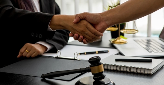 lawyer shakes hand of new client