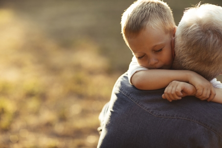 grandfather hugging grandson