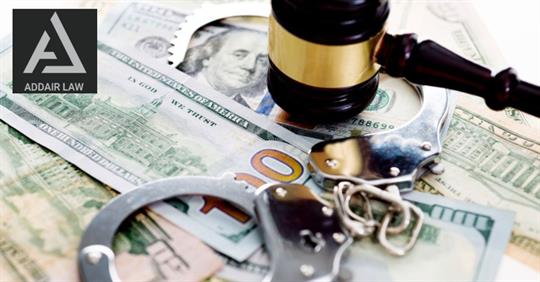 handcuffs, gavel, and money